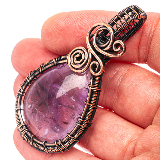 Amethyst wire-wrapped teardrop pendant with oxidized copper coils and spirals