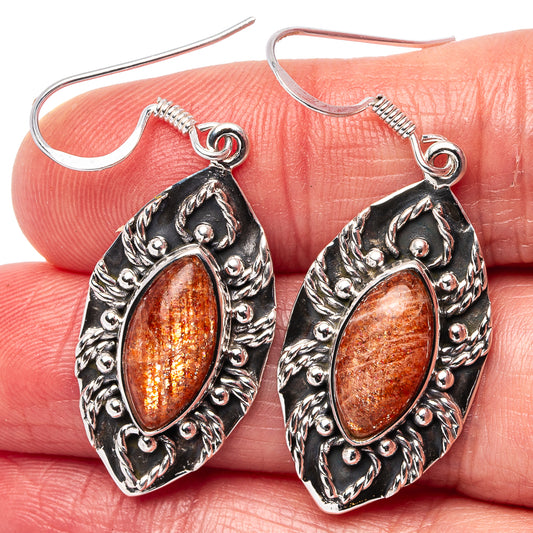 Sterling silver sunstone earrings with textured filigree and oval amber-orange stones