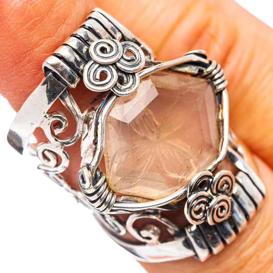 Rose quartz sterling silver ring with ornate filigree band and rose-pink teardrop stone