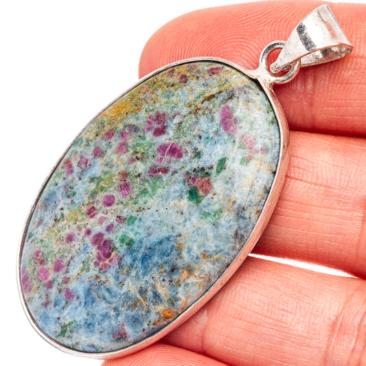 Oval kyanite pendant with multicolor speckled stone, silver-plated bail loop