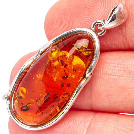 Oval amber pendant with .925 sterling silver bezel and top loop bail, warm orange