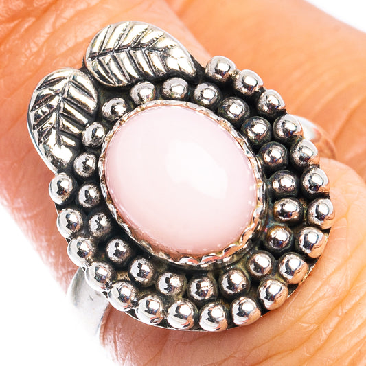Sterling silver pink opal ring with round pink cabochon and beaded halo
