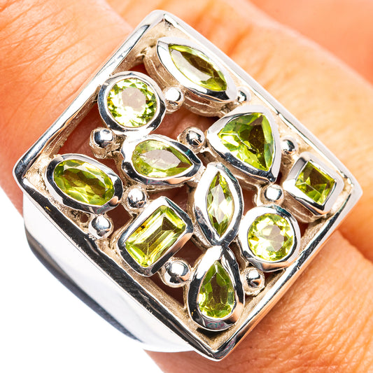 Peridot ring on finger, square frame with oval green gemstones in .925 silver