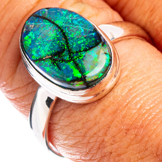Oval opal cabochon sterling silver ring with vibrant green-blue iridescence, size 9