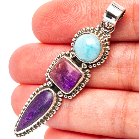 Sterling silver pendant with round light-blue larimar and purple sugilite cabochons