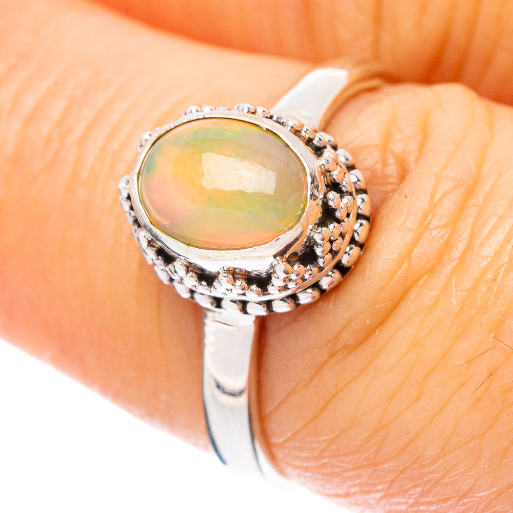 Oval Ethiopian opal cabochon ring in 925 sterling silver, ornate halo setting