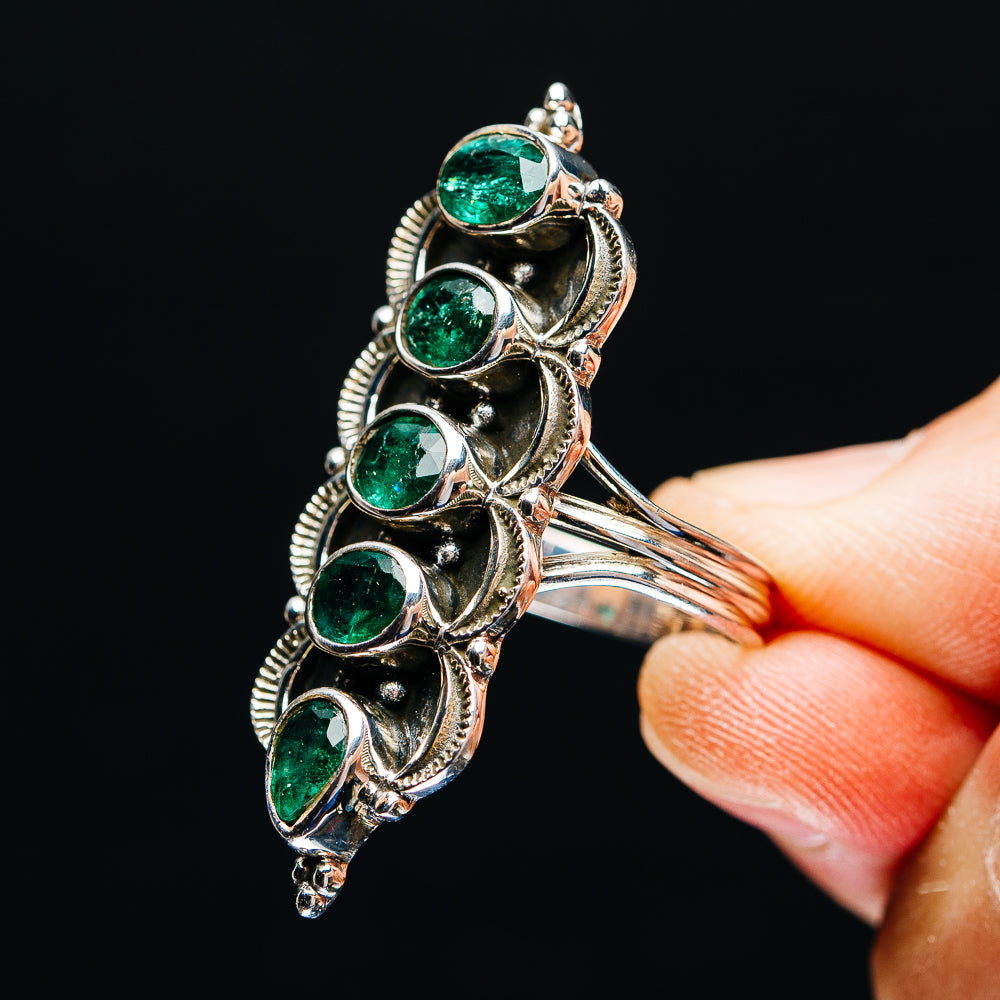 Sterling silver emerald ring detail view, five green stones in ornate scroll setting