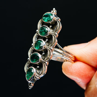 Sterling silver emerald ring detail view, five green stones in ornate scroll setting
