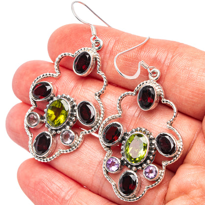 Sterling silver drop earrings with green, red, and purple oval gemstones in ornate settings