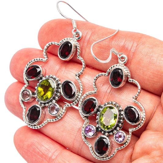 Sterling silver drop earrings with green, red, and purple oval gemstones in ornate settings
