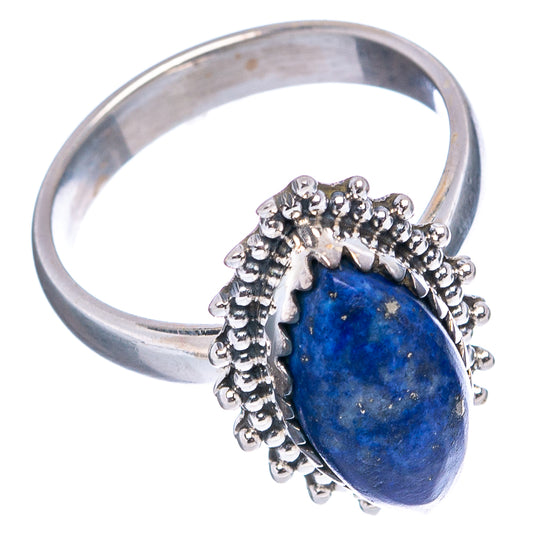 Lapis lazuli ring with wide silver band and oval blue stone in beaded frame