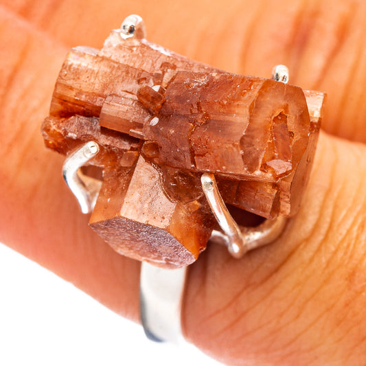 Raw orange aragonite ring with faceted crystal in sterling silver prong setting