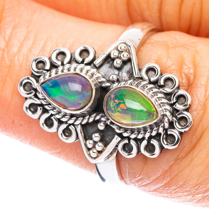 Sterling silver opal ring with two oval green-blue multicolor gemstones, ornate bezel