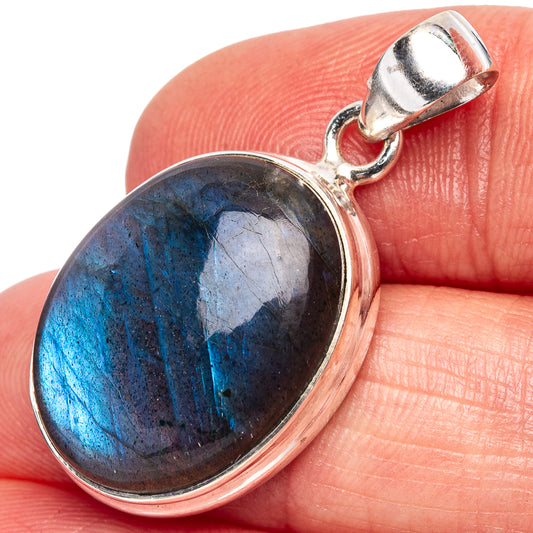 Oval labradorite pendant in .925 sterling silver with blue flash bezel and bail.