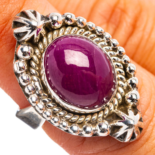 Sterling silver adjustable ring with oval purple star ruby cabochon and ornate bezel