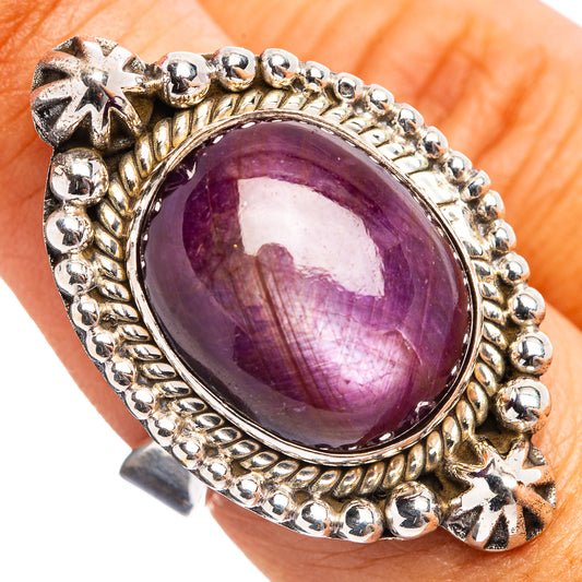 Sterling silver ring with oval purple gemstone and ornate bezel setting
