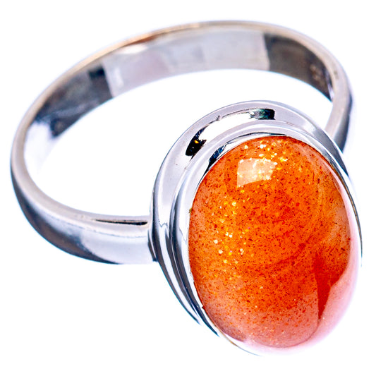 Sterling silver sunstone ring with glossy oval orange cabochon, polished band, size 6.5