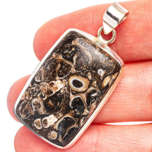 Turritella agate pendant in rectangular bezel, dark fossil-pattern stone, silver bail