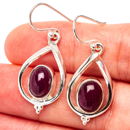 Sterling silver ruby drop earrings with oval purple-red gemstone, hinged hooks