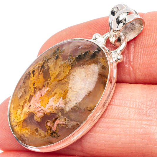 Oval plume agate pendant in sterling silver with textured amber, brown, and purple stone