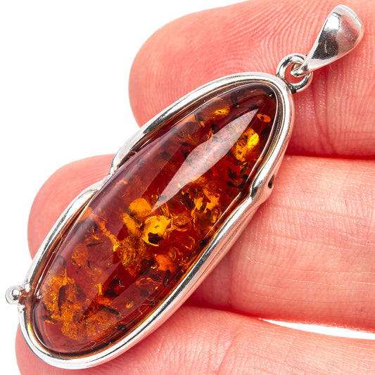 Amber pendant with oval amber cabochon set in .925 sterling silver bail