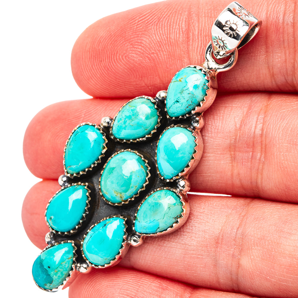 Turquoise and sterling silver pendant with oval stones in black setting on bail