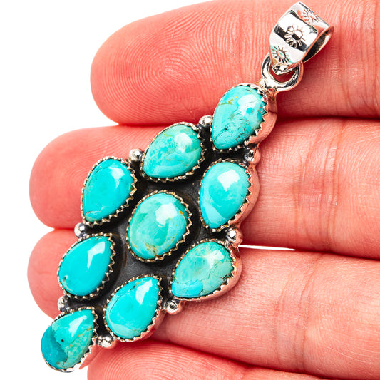 Turquoise and sterling silver pendant with oval stones in black setting on bail