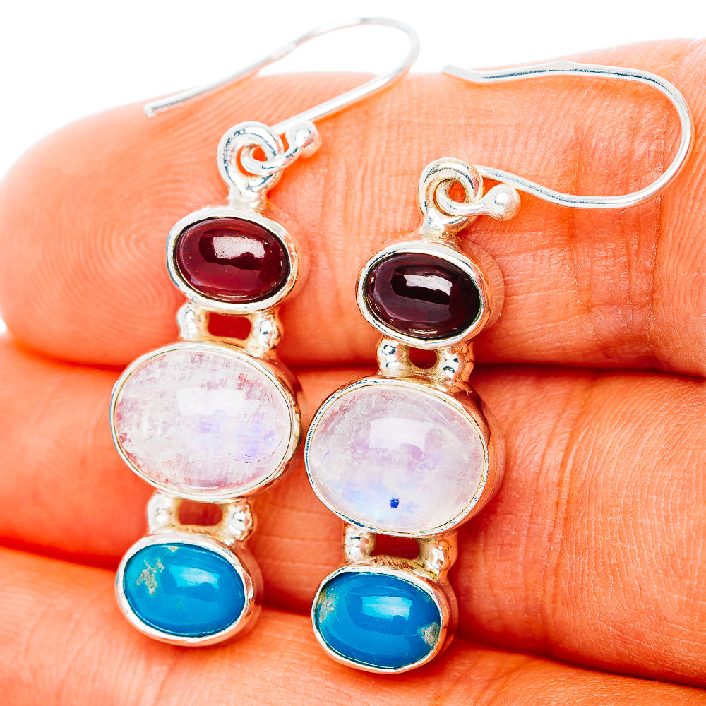Sterling silver drop earrings with red, moonstone, and blue cabochon stones
