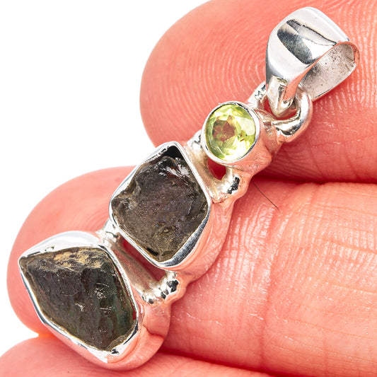 Sterling silver peridot and moldavite-style pendant, close-up on bezel and prong setting