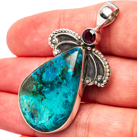 Sterling silver pendant with turquoise teardrop stone, red garnet accent, loop bail.