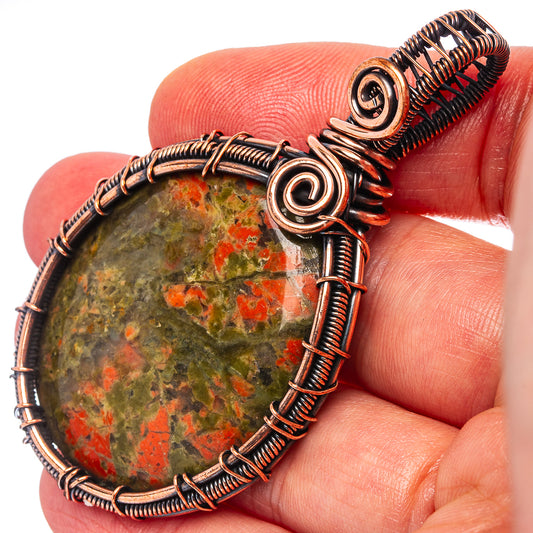 Unakite wire-wrap pendant with green stone and red flecks, oxidized copper wire setting