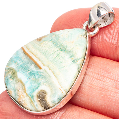Teardrop aragonite pendant in silver setting with blue-green stone and rounded bail