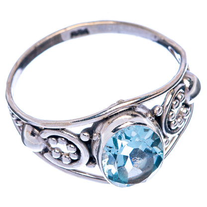 Sterling silver ring with blue topaz round faceted stone and side scrollwork