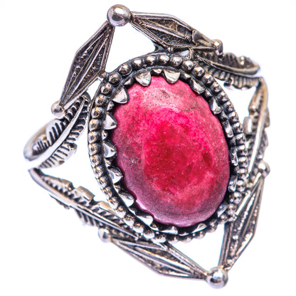 Rhodochrosite ring featuring oval pink gemstone in detailed sterling silver bezel frame