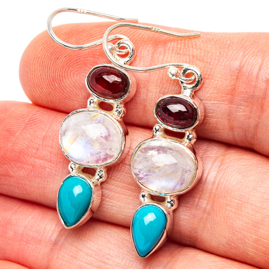 Sterling silver drop earrings with moonstone discs, garnet hearts, and turquoise teardrops