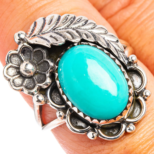 Oval turquoise cabochon sterling silver ring with floral and leaf filigree settings