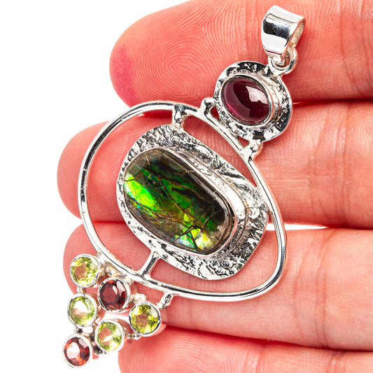 Sterling silver pendant with green iridescent oval and red plus green round accents