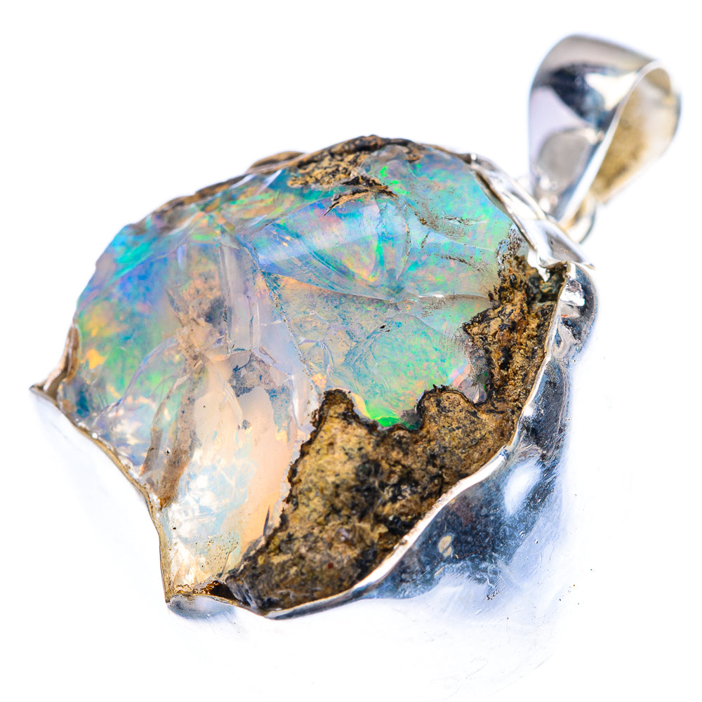 Rough opal pendant in 925 sterling silver, blue-green flashes with dark stone matrix