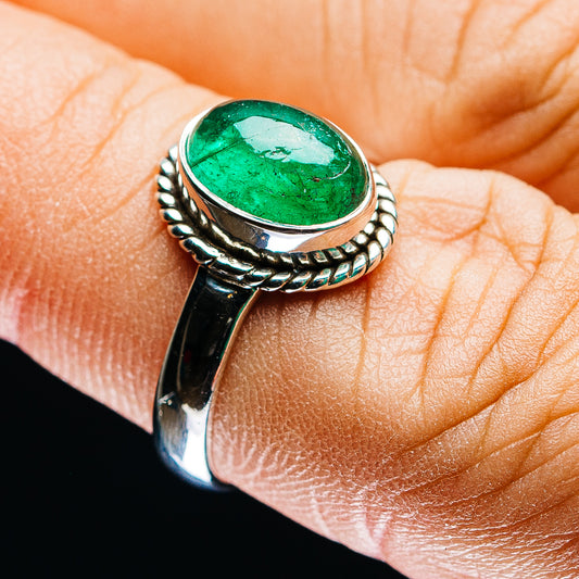 Sterling silver emerald ring with oval green gemstone and braided bezel, size 7