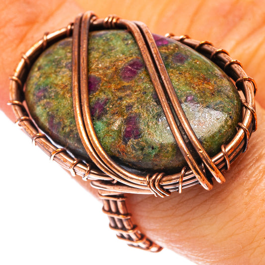 Oxidized copper wire-wrapped oval fuchsite stone ring with ruby-like flecks, flat view