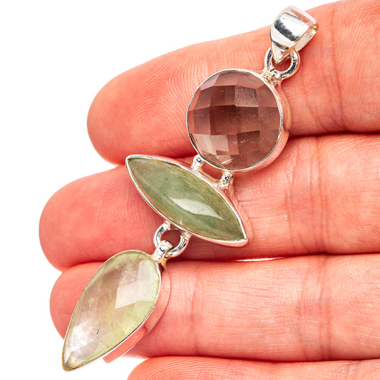 Sterling silver pendant with round faceted stone and green teardrop gemstone