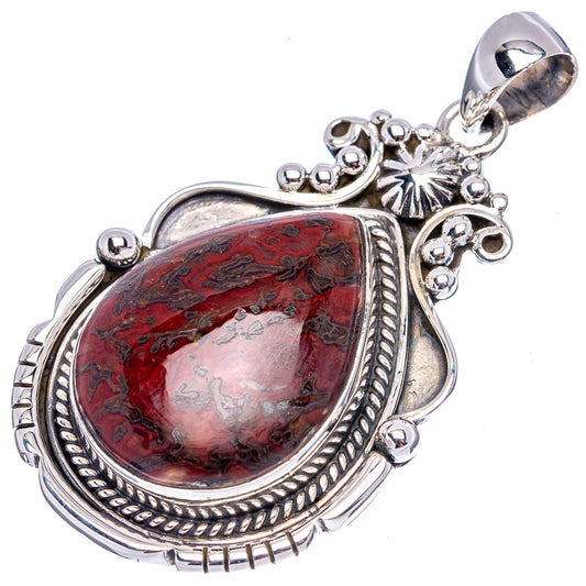 Sterling silver pendant with red mottled teardrop stone, loop bail, and carved edge