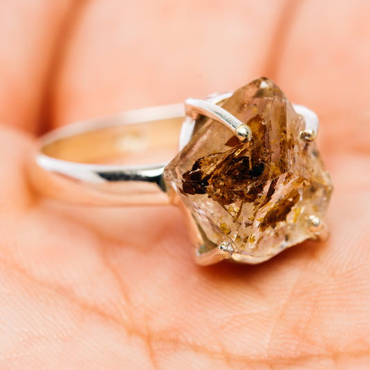 Sterling silver ring with an irregular petroleum quartz gemstone and visible prongs