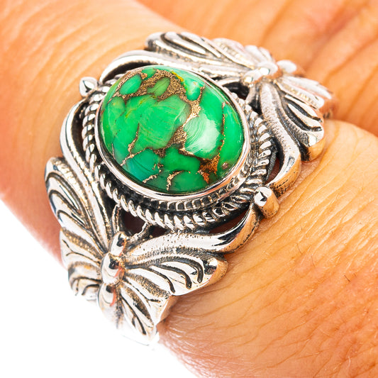 Sterling silver ring with green turquoise oval cabochon and ornate leaf/butterfly setting