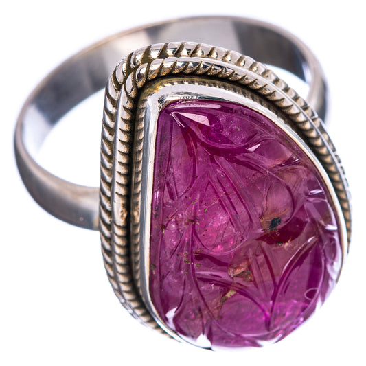 Carved ruby ring with oval purple-red stone and rope border on sterling silver band