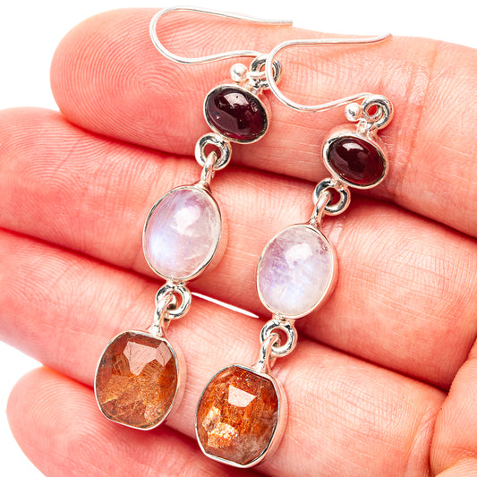 Sterling silver drop earrings with dark red, white opal, and orange gemstone dangles