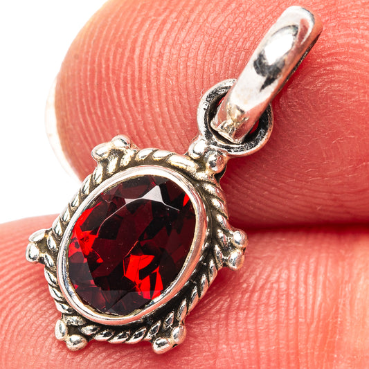 Garnet pendant with oval faceted red gemstone in sterling silver frame