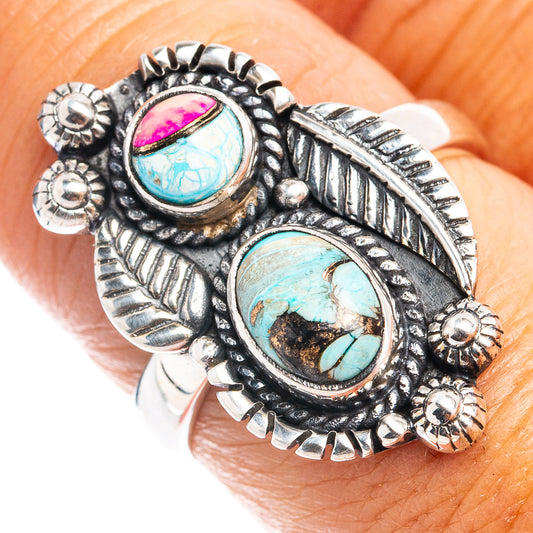 Sterling silver ring with ornate feather setting and two oval stones, pink and turquoise