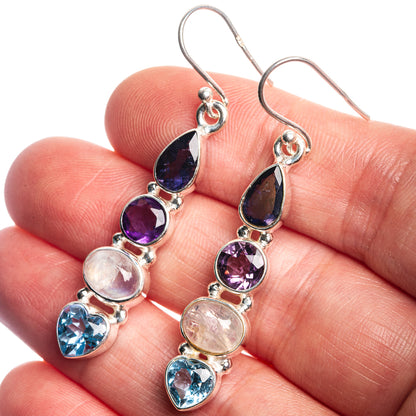 Sterling silver drop earrings with dark blue, purple, rose, and light blue gemstones