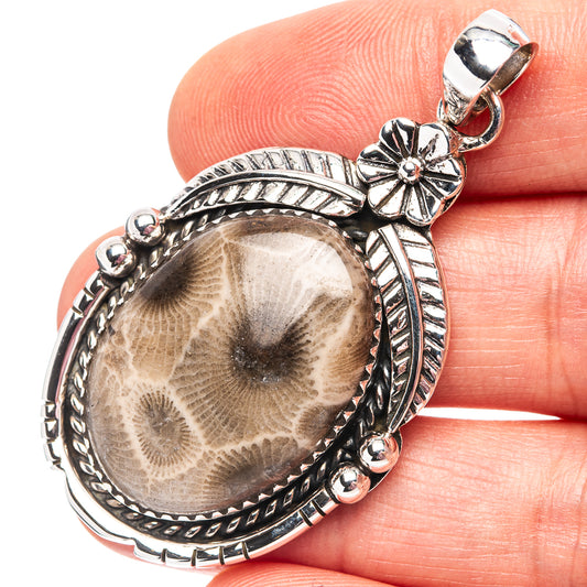 Sterling silver fossil coral pendant with oval fossil insert and ornate bezel